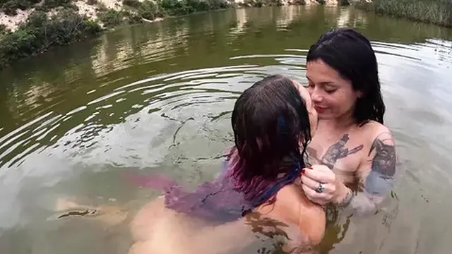 Two sweet girls enjoying each other by the lake
